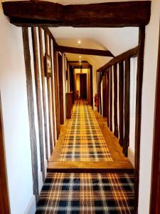 a hallway with a stairway leading into a room at The Harvard Inn in Stock