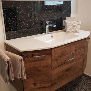 a bathroom vanity with a sink and a mirror at Ferienwohnung Frieda in Sillian