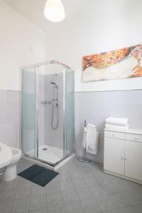 a white bathroom with a shower and a toilet at Apartment Palazzuolo in Florence