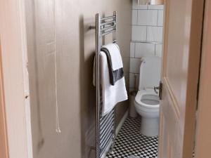 a bathroom with a toilet and a towel rack at Pass the Keys Cozy two bed flat near Glasgow Airport & Paisley in Paisley