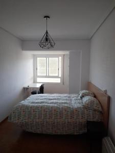 ein weißes Schlafzimmer mit einem Bett und einem Fenster in der Unterkunft Torresmar home in Segorbe