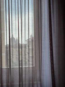 a close up of a window with white curtains at GRAFEA Apartment Catania in Catania