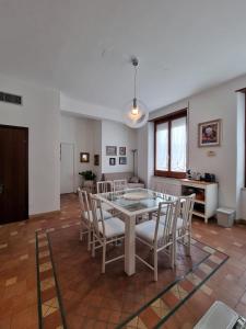 a dining room with a white table and chairs at GRAFEA Apartment Catania in Catania