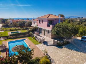 an aerial view of a house with a swimming pool at Villa Syriti in Skala