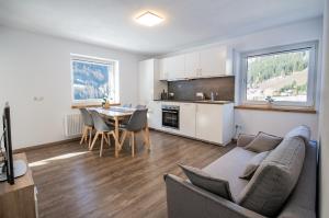 a living room and kitchen with a couch and a table at Ferienwohnung Katarina in Vals