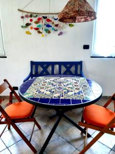 a blue table with a mosaic table cloth on it at L'Antico Frantoio in Rapallo +10 photos