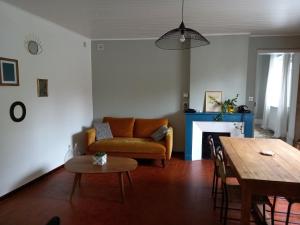 a living room with a couch and a table at La Maison Molières in Montauban