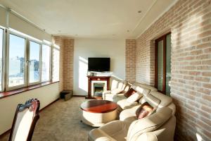 a living room with a couch and a tv at Business Penthouse in the center in Kazan
