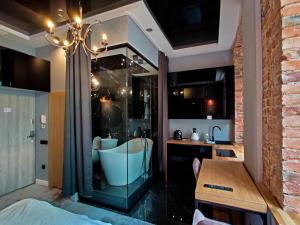 a bathroom with a bath tub and a sink at Piotrkowska.eu Apartament Romantica in Łódź