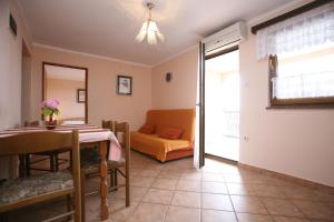 a living room with a table and a couch at Apartments Neda - Poreč South in Poreč +35 photos