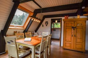 a dining room with a wooden table and chairs at Eulenhäusle in Schramberg