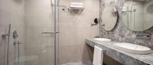 a bathroom with a shower and a sink and a mirror at Melas Hotel Istanbul in Istanbul
