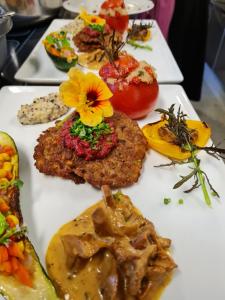 a white plate topped with different types of food at Berghotel Gerlosstein in Hainzenberg