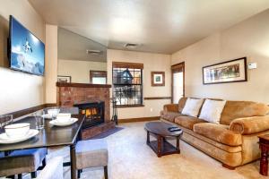 a living room with a couch and a table at K B M Resorts- CBI-103 Upgraded 1Bd, wood fireplace, full kitchen, wifi, walk to slopes in Park City