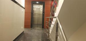 a hallway with a elevator in a building at Hotel Teeja's - Haldi Restaurant Aiims road Jodhpur in Jodhpur