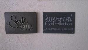 two signs on a wall with an essential hotel collection at The Atlantis Historic Inn in Saint Joseph