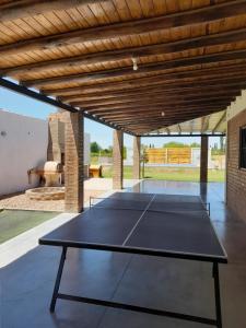 a ping pong table in the middle of a patio at Cabañas El Kincho in Albardón