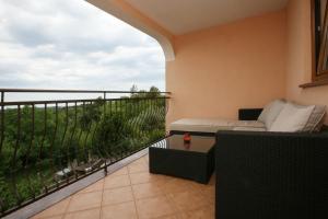 a balcony with a couch and a view at Apartments Neda - Poreč South in Poreč