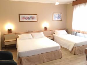 Posteľ alebo postele v izbe v ubytovaní Cosmos Hotel