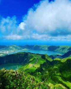 a view of a valley with a lake and mountains at Azores Casa da Mata in São Vicente Ferreira