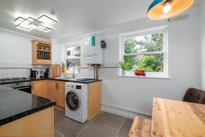 a kitchen with a washer and dryer in it at Beautiful 4 bedroom terrace house in Kings in London