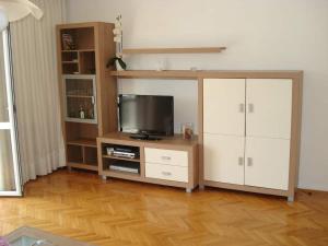 a living room with a tv and a entertainment center at Apartments Luka in Korčula