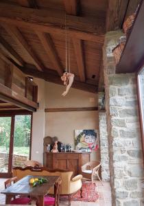 a living room with a table and a stone wall at TERRALUNA Villa Vacanze San Leo - San Marino in San Leo