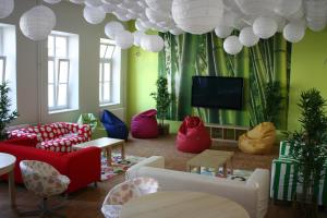 a living room with colorful furniture and a flat screen tv at Hostel Tabor in Ljubljana