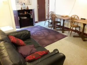 a living room with a couch and a table and chairs at Lantern House in Cambridge