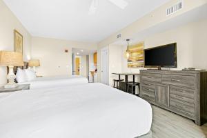 a bedroom with two beds and a flat screen tv at Elation #5216 in Destin