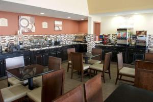 a restaurant with tables and chairs and a counter at Best Western Green Tree Inn in Clarksville