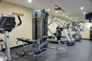 a gym with several tread machines in a room at Best Western Green Tree Inn in Clarksville