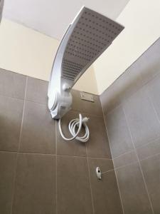 a shower in a bathroom with a white object on the floor at Casa Mesa in Guatemala