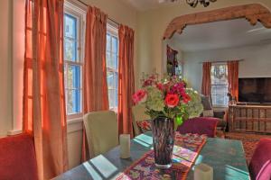 a dining room with a table with a vase of flowers at Cozy Adobe Casita 1 Mile to Santa Fe Plaza! in Santa Fe