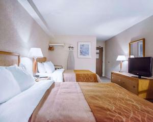Habitación de hotel con 2 camas y TV de pantalla plana. en Rodeway Inn Saint John, en Saint John