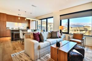 a living room with a couch and a table at Lift Park City Condominiums by Vail Resorts in Park City