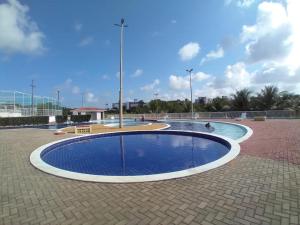 a large circular pool in a courtyard with a sky at Condomínio encantador próximo a praia , 3 quartos. in João Pessoa