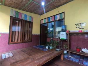 a room with a wooden bench and a window at OWL HOSTEL Karimunjawa in Karimunjawa