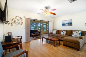 a living room with a couch and a ceiling fan at By the Bay in Sarasota