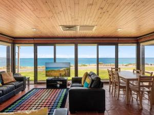 a living room with a view of the ocean at Gold Coast Views 10 Gold Coast Drive in Normanville