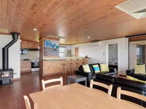 a living room with a couch and a table at Gold Coast Views 10 Gold Coast Drive in Normanville