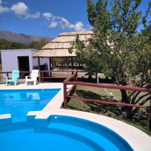 a villa with a pool and a gazebo at Cabañas Yanasuy in Merlo