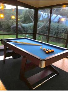 a pool table with cue balls on top of it at Duvauchelle Dream in Duvauchelle