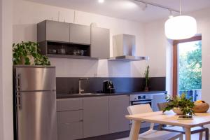a kitchen with a stainless steel refrigerator and a table at Casa Dubi. Kvarner in Selce