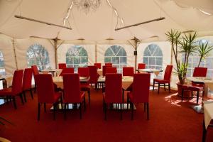 a dining tent with tables and chairs in it at Hotel Endorfer Hof in Bad Endorf