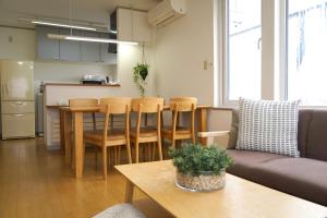 a living room with a couch and a table at Smart Hotel Kutchan in Kutchan