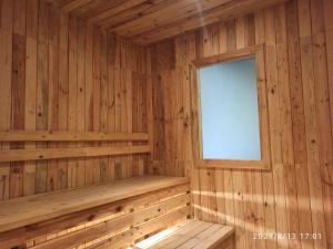 a wooden sauna with a window in it at DWan Tea Mountain Side in Jatiluwih