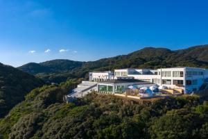 an aerial view of a building in the hills at アシズリテルメ in Isa