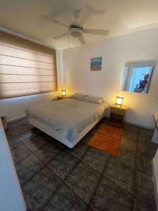 a bedroom with a bed and two lights on two tables at Beachside apartment with 2 pools, Same, Esmeraldas in Volcán Chimborazo