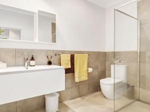 a bathroom with a sink and a toilet at Windspray in Culburra Beach